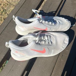 White Nike tennis shoes with bright orange swish